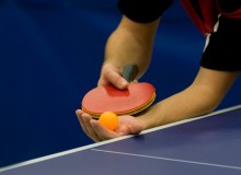 Mans hands about to serve a game of table tennis