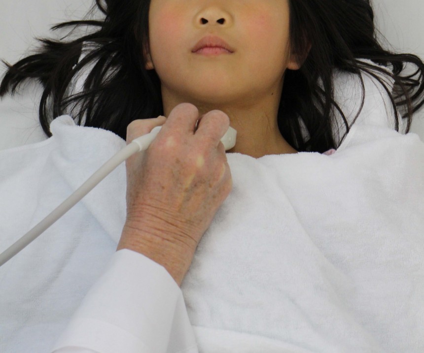 A child receives a thyroid exam in A2-B-C. Photo by Ian Thomas Ash.