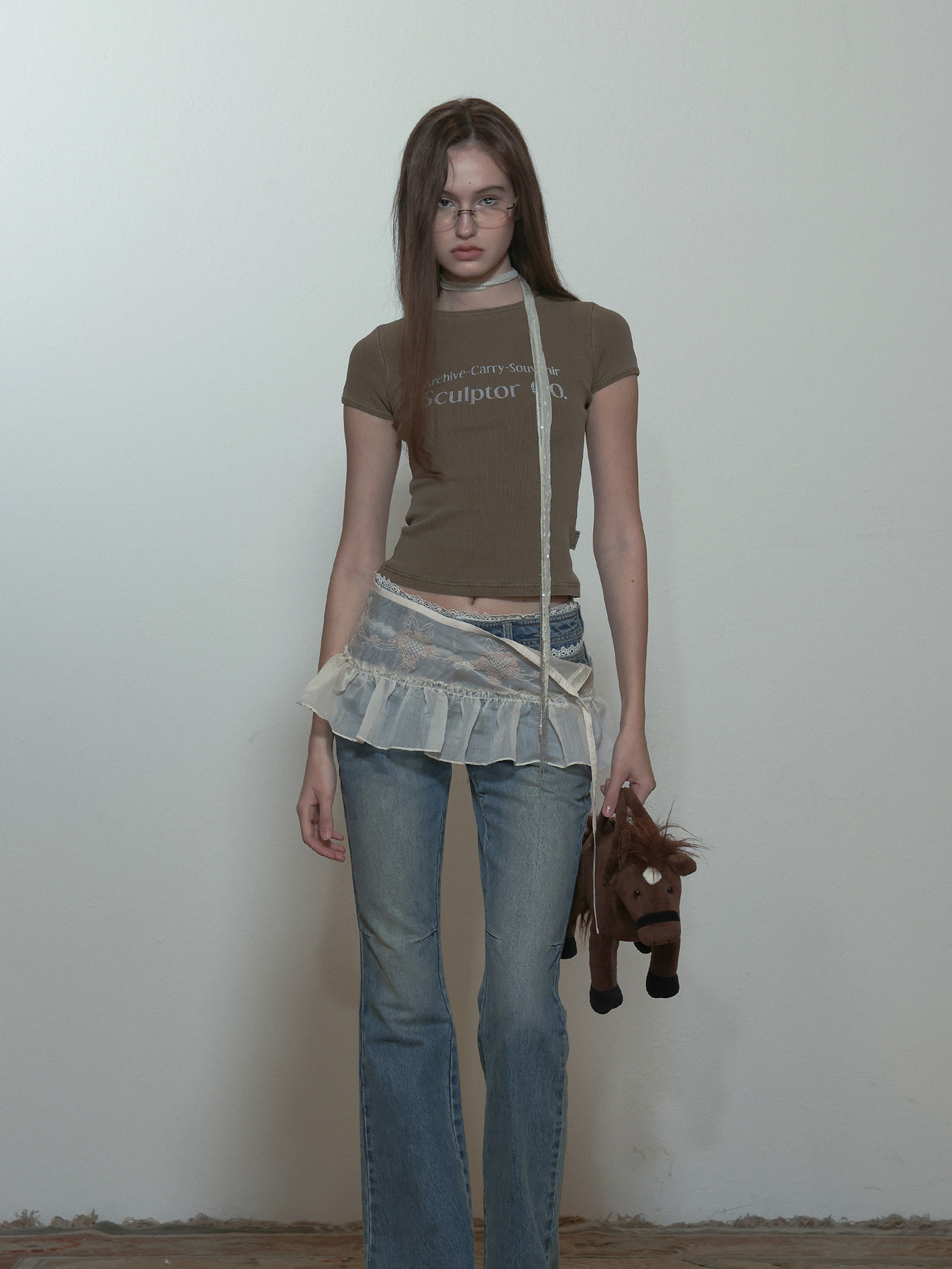 image of sculptor peekaboo micro sheer skirt paired with jeans