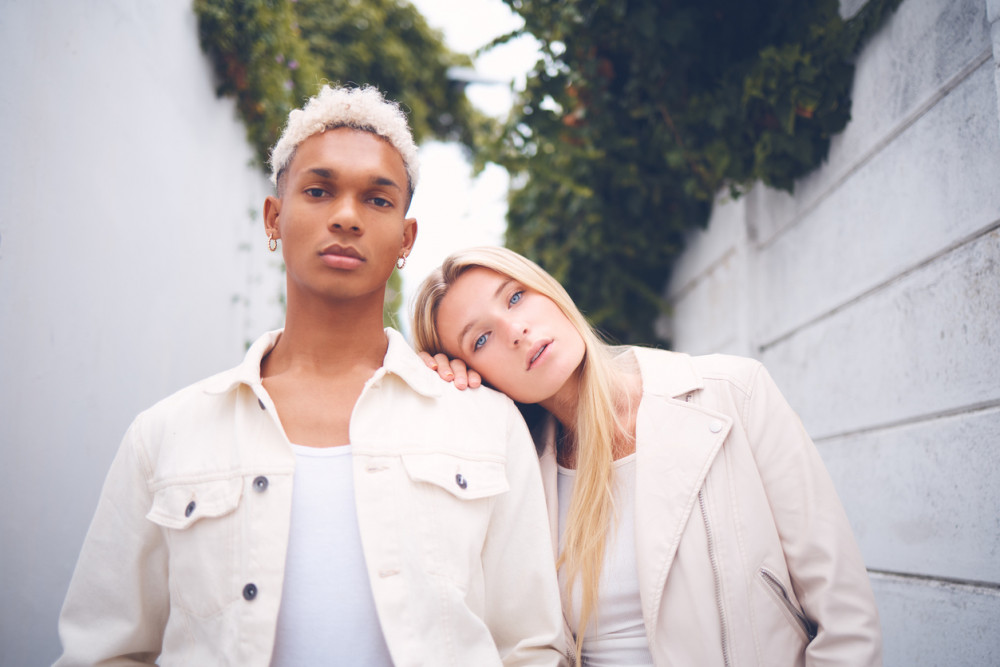 androgynous fashion, two people wearing bright clothes with a more gender-neutral approach to their looks