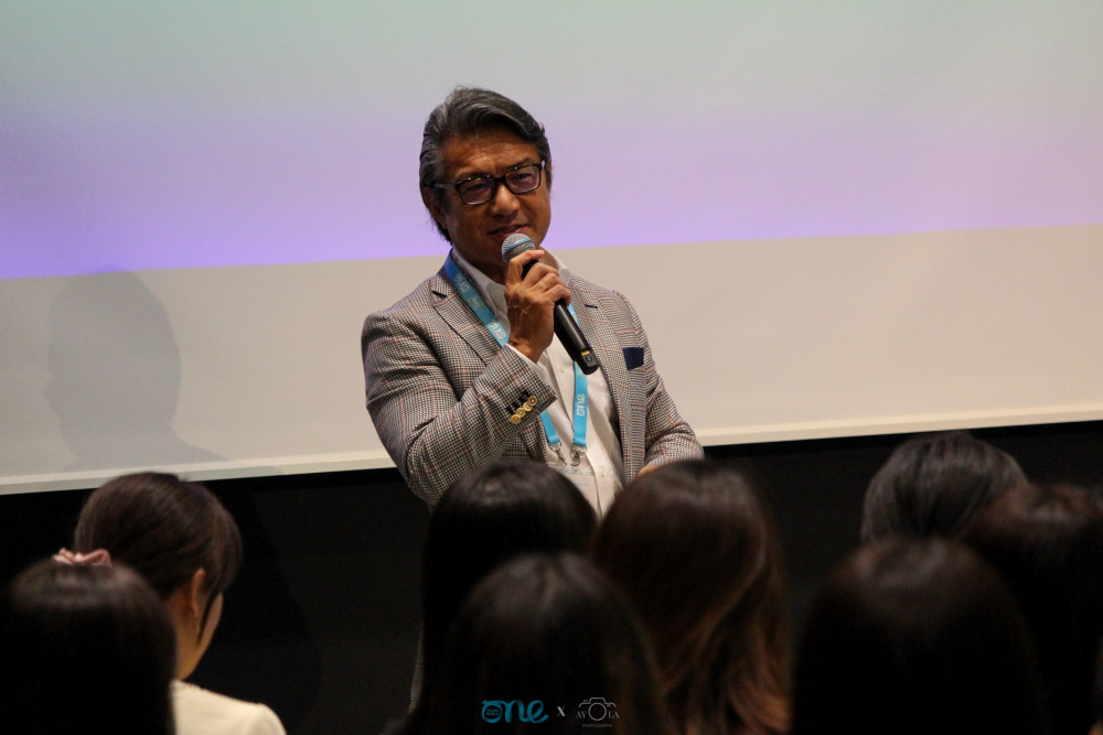 One Young World chairperson Kimy Okubo speaking in front of an audience