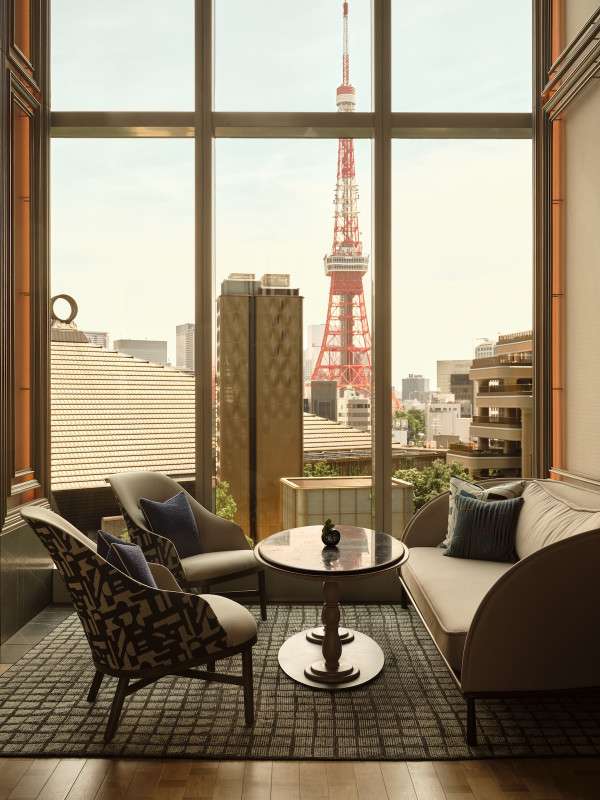 The view from the Janu Lounge with Tokyo Tower, during the day. With luxurious couches and chairs.