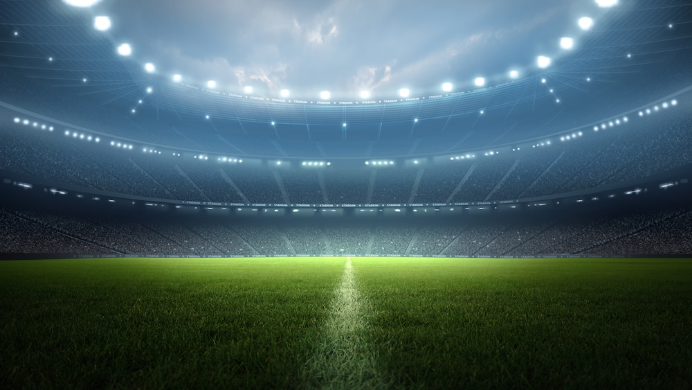 A large soccer stadium is lit up at night in preparation for the FIFA World Cup 2026 and the Japan Team Game.