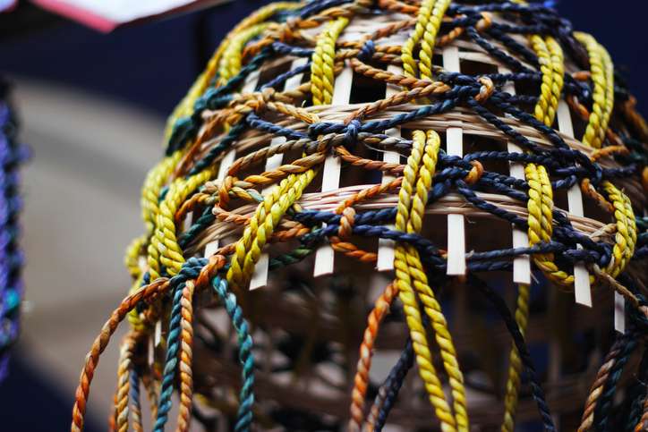A traditional Japanese kumihimo braid woven in yellow, dark blue, and orange using the kumihimo braiding technique.